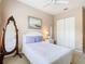 Bright bedroom with queen bed, large full length mirror and a closet with ample storage space at 205 Terrace Ridge Cir # 205, Davenport, FL 33896