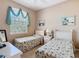 Cozy bedroom with two twin beds, large window with lots of natural light, and neutral colored walls at 205 Terrace Ridge Cir # 205, Davenport, FL 33896