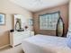 Cozy bedroom with large queen bed, a dresser with large mirror and a window with natural lighting at 205 Terrace Ridge Cir # 205, Davenport, FL 33896