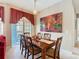Cozy dining room featuring a wooden table with six chairs and an eye-catching art piece at 205 Terrace Ridge Cir # 205, Davenport, FL 33896