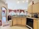 Functional kitchen featuring light wood cabinets and black appliances, open to the living spaces at 205 Terrace Ridge Cir # 205, Davenport, FL 33896