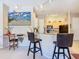 Eat-in kitchen with bar seating, light wood cabinets, and modern black appliances, perfect for entertaining at 205 Terrace Ridge Cir # 205, Davenport, FL 33896