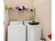 Convenient laundry room features a washer and dryer, shelves with detergents and cleaning supplies at 205 Terrace Ridge Cir # 205, Davenport, FL 33896