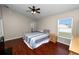 Bright bedroom with wood floors, ceiling fan, and window offering natural light, creating a relaxing space at 2160 Country Manor St, Bartow, FL 33830