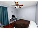Comfortable bedroom with a ceiling fan, modern desk, and curtains for privacy, perfect for relaxation and productivity at 2160 Country Manor St, Bartow, FL 33830