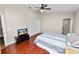 Cozy bedroom features wood floors, a ceiling fan, and an ensuite bathroom with a glass-enclosed shower at 2160 Country Manor St, Bartow, FL 33830