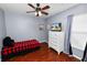 The bedroom features wood floors, a ceiling fan, and a large window letting in natural light at 2160 Country Manor St, Bartow, FL 33830