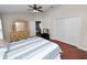 Bedroom with wood floors, ceiling fan, and double closet, offering ample storage and comfort at 2160 Country Manor St, Bartow, FL 33830
