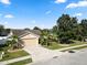 Well-maintained single-Gathering home featuring a two-car garage, manicured lawn, and lush landscaping at 2160 Country Manor St, Bartow, FL 33830