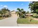 Charming one-story home featuring a well-manicured lawn and mature landscaping at 2160 Country Manor St, Bartow, FL 33830