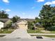 Charming home featuring a well-manicured lawn, mature trees, and a spacious driveway at 2160 Country Manor St, Bartow, FL 33830