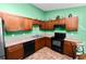 Bright eat-in kitchen features wooden cabinets, black appliances and tile floors at 2160 Country Manor St, Bartow, FL 33830