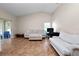 Open living room showcasing neutral furniture, tiled floors, and natural light streaming in from a glass sliding door at 2160 Country Manor St, Bartow, FL 33830