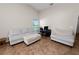 Bright living room features neutral-toned furniture, tiled flooring, and a dedicated workspace with a desk and chair at 2160 Country Manor St, Bartow, FL 33830