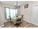 Charming dining area with a round table, elegant chandelier, and wood-look floors at 2420 Delrose E Dr, Lakeland, FL 33805