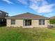 A well-maintained backyard featuring a green lawn and partial view of the home's exterior at 2454 Harrison Place Blvd, Lakeland, FL 33810