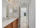 Bright bathroom featuring a vanity with a sink and a view to another room at 2454 Harrison Place Blvd, Lakeland, FL 33810