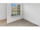 Cozy bedroom featuring neutral carpet, white walls, and a window providing natural light at 2454 Harrison Place Blvd, Lakeland, FL 33810