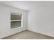 Neutral-toned bedroom with a window providing natural light and a carpeted floor at 2454 Harrison Place Blvd, Lakeland, FL 33810