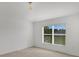 Bright bedroom with neutral carpet, large window with blinds and a ceiling light at 2454 Harrison Place Blvd, Lakeland, FL 33810