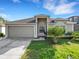 Charming single-story home with attached garage and well-manicured landscaping at 2454 Harrison Place Blvd, Lakeland, FL 33810