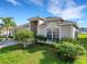 Charming single-story home boasts lush landscaping and a well-maintained lawn under a sunny sky at 2454 Harrison Place Blvd, Lakeland, FL 33810