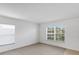 Spacious living room featuring neutral carpet, white walls, and a large window for ample natural light at 2454 Harrison Place Blvd, Lakeland, FL 33810