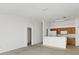 Open-concept living room with neutral carpet and views into the kitchen at 2454 Harrison Place Blvd, Lakeland, FL 33810