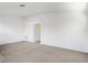 Expansive living room with neutral carpet and white walls, showcasing an arched doorway and airy feel at 2454 Harrison Place Blvd, Lakeland, FL 33810