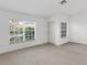 Bright living room with neutral carpet, white walls, and large windows offering plenty of natural light at 2454 Harrison Place Blvd, Lakeland, FL 33810