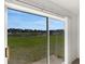 Sliding glass doors offer stunning backyard views of the green space and pond at 2454 Harrison Place Blvd, Lakeland, FL 33810
