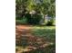 Spacious backyard partially enclosed by a chain-link fence with leafy trees offering plenty of shade at 256 Village View Ln, Lakeland, FL 33809
