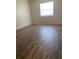 Inviting bedroom with warm hardwood flooring and a bright window at 256 Village View Ln, Lakeland, FL 33809