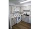 Bright kitchen features white cabinets, modern black sink and faucet, and updated appliances at 256 Village View Ln, Lakeland, FL 33809