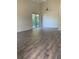 Bright living room with hardwood floors, a ceiling fan, and sliding glass doors at 256 Village View Ln, Lakeland, FL 33809