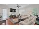 Bright living area featuring hardwood floors, fireplace, and a comfortable white sofa at 2610 Grace Manor Drive, Lakeland, FL 33812