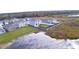 Aerial view of a neighborhood bordered by a scenic lake shows the homes and surrounding greenery at 2816 Ivy Lake Ct, Lakeland, FL 33811
