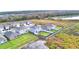 An aerial shot of a neighborhood located near a serene lake, with a railway in the background at 2816 Ivy Lake Ct, Lakeland, FL 33811