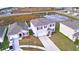 Overhead shot of a neighborhood shows manicured lawns and the proximity to green spaces and a pond at 2816 Ivy Lake Ct, Lakeland, FL 33811