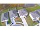 Aerial view of a neighborhood showcases well-maintained homes, lawns, and a scenic pond in the background at 2816 Ivy Lake Ct, Lakeland, FL 33811