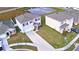 An aerial shot of a neighborhood highlights the homes, driveways, landscaping, and a tranquil pond at 2816 Ivy Lake Ct, Lakeland, FL 33811