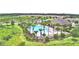 An aerial view reveals the community pool, clubhouse, lush landscaping and modern homes with nearby green spaces at 2816 Ivy Lake Ct, Lakeland, FL 33811