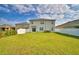 Large backyard showing the home's exterior and a well-maintained lawn at 2816 Ivy Lake Ct, Lakeland, FL 33811