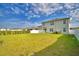 Wide shot of the fenced in backyard with healthy grass at 2816 Ivy Lake Ct, Lakeland, FL 33811