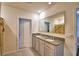 Bright bathroom with double sink vanity, granite counters, and decorative mirror at 2816 Ivy Lake Ct, Lakeland, FL 33811