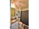 Bathroom featuring granite countertop, tiled floors, dark shower curtain and decorated shelves at 2816 Ivy Lake Ct, Lakeland, FL 33811