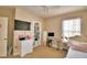 Bedroom featuring a ceiling fan, mounted TV and ample storage at 2816 Ivy Lake Ct, Lakeland, FL 33811