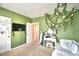 Green bedroom featuring daybed, vanity and hanging foliage at 2816 Ivy Lake Ct, Lakeland, FL 33811