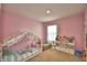 Pink bedroom features a canopy bed, and a shelved wall unit for storage at 2816 Ivy Lake Ct, Lakeland, FL 33811