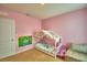Pink bedroom featuring a whimsical canopy bed and toys at 2816 Ivy Lake Ct, Lakeland, FL 33811